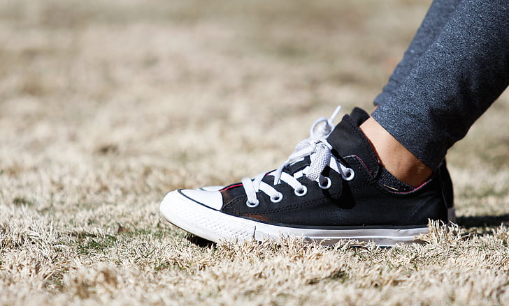 shallow focus photography of pair of black-and-white low-top sneakers