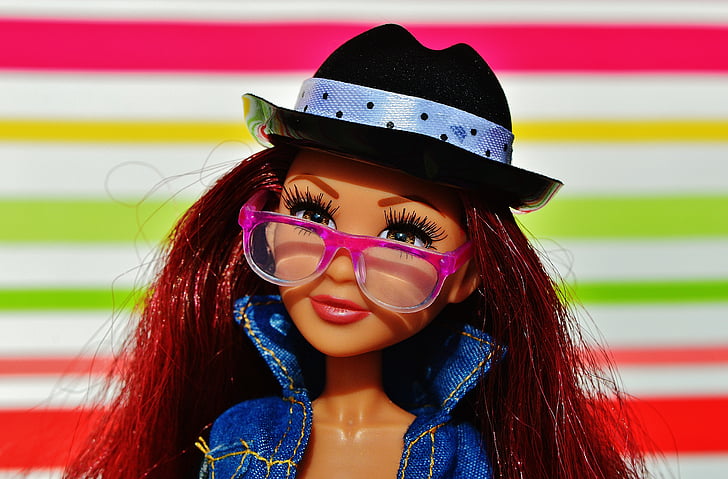 Barbie doll with pink eyeglasses and blue denim jacket