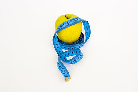 green apple and blue tape measure