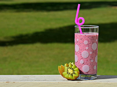 white drinking glass filled with pink liquid