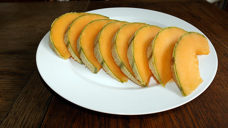 sliced melons on white plate