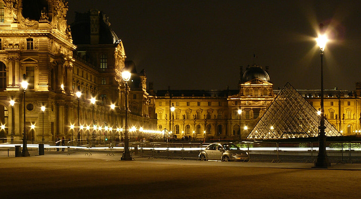 timelapse photography silver Volkswagen New beetle near Louvre Museum at night time