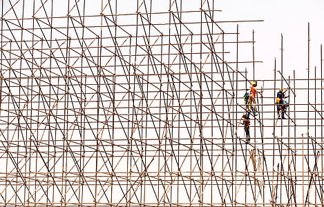 several men on bamboo scaffolding