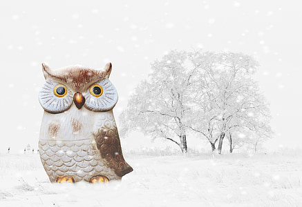 brown owl figurine on snow