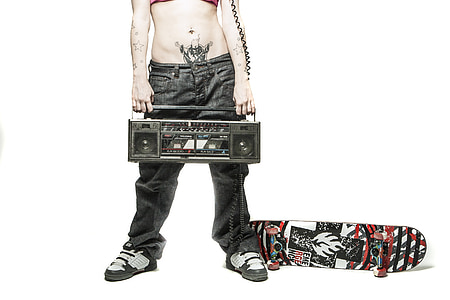 person holding boombox with skateboard photography