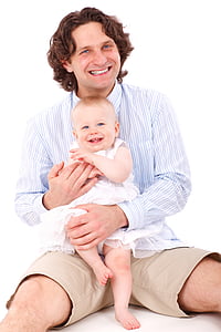 man sitting on floor holding baby girl