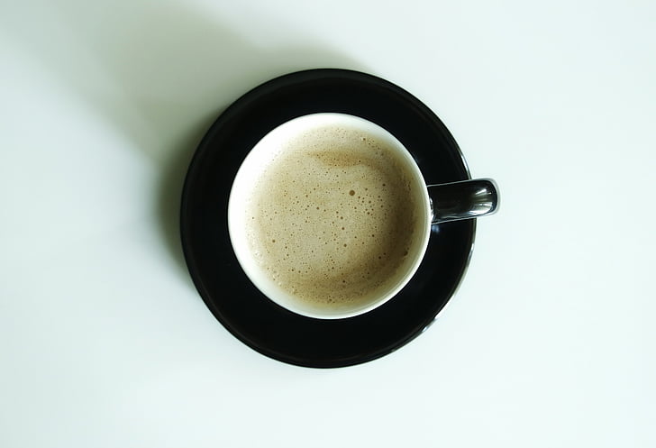coffee on a black ceramic saucer
