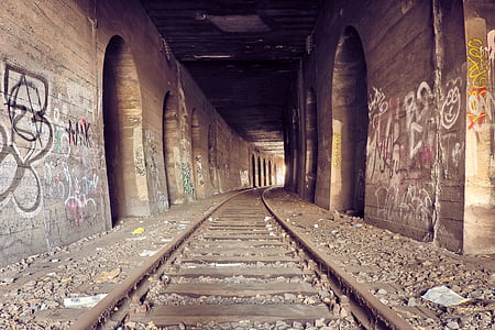 brown railway inside tunnel
