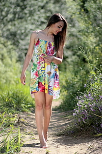 woman wearing white, green, and red floral spaghetti strap sundress