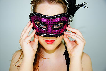 photography of woman wearing purple and black masquerade mask