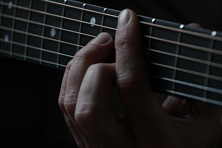 person holding guitar strings