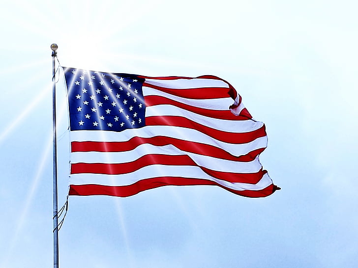 flag of U.S.A hanged on gray metal pole at daytime