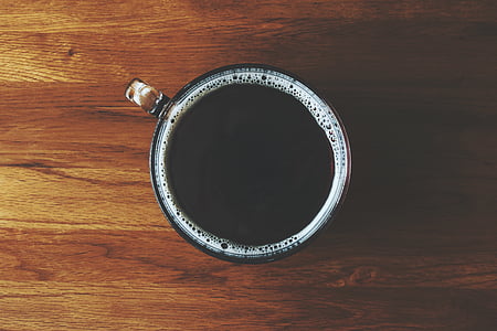 close-up photo of round white ceramic mug filled with coffee