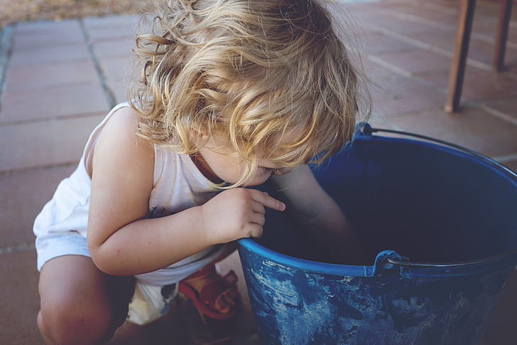 toddler looking in bucket