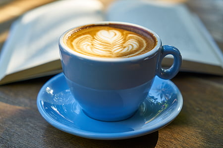 blue ceramic mug filled with coffee on saucer