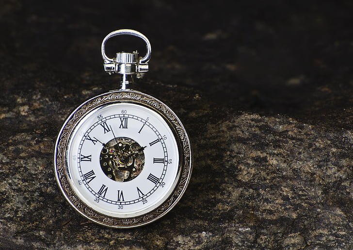 selective focus photography of silver-colored pocket watch