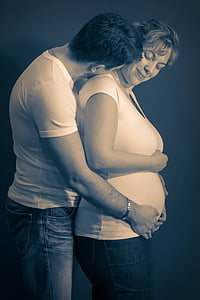 man hugging pregnant woman photo