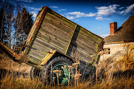 green and black metal framed wagon on brown grass field