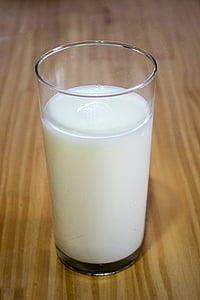 milk in clear glass on table