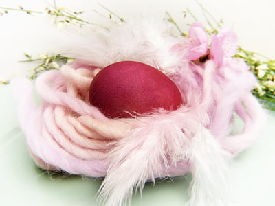 red egg covered by pink rope