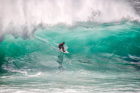 man surfing on blue ocean during daytime