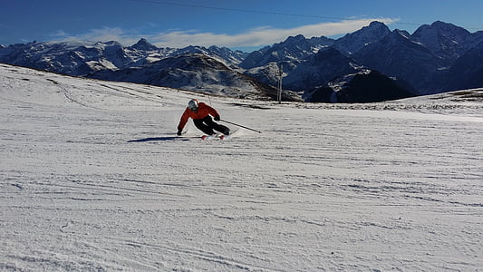 person riding on snowski during daytime photography