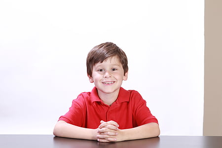 photo of boy wearing red polo shirt