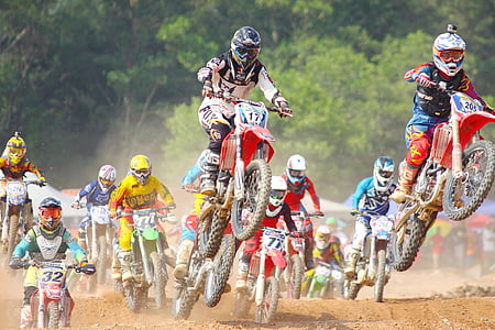people riding on motocross at daytime
