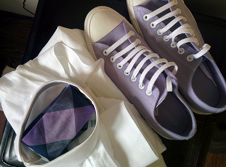 purple low-top sneakers beside white textile