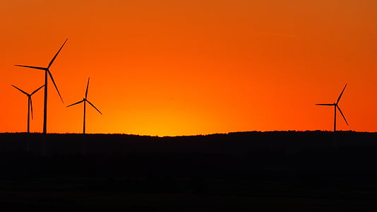 silhouette of windmills during sunset