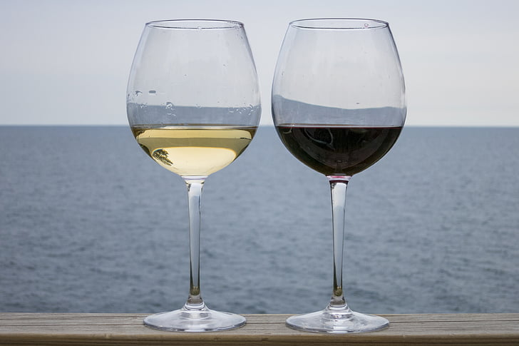 two wine glasses filled with drinks
