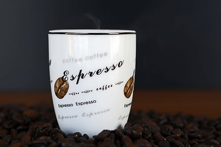 white Espresso printed cup on coffee beans