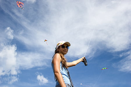 woman holding a wire with kite