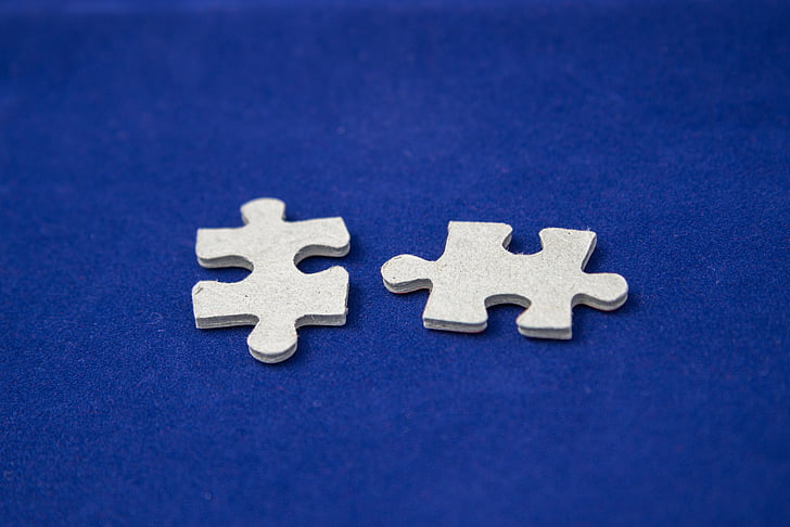 two white jigsaw puzzle pieces