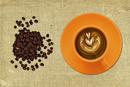 brown coffee beans near orange mug