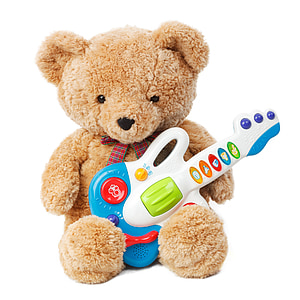 brown bear holding white and blue guitar toy