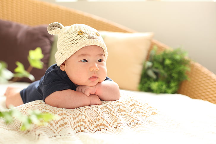 baby wearing beige beanie hat
