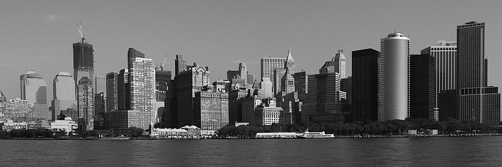 grayscale photo of cityscape by water