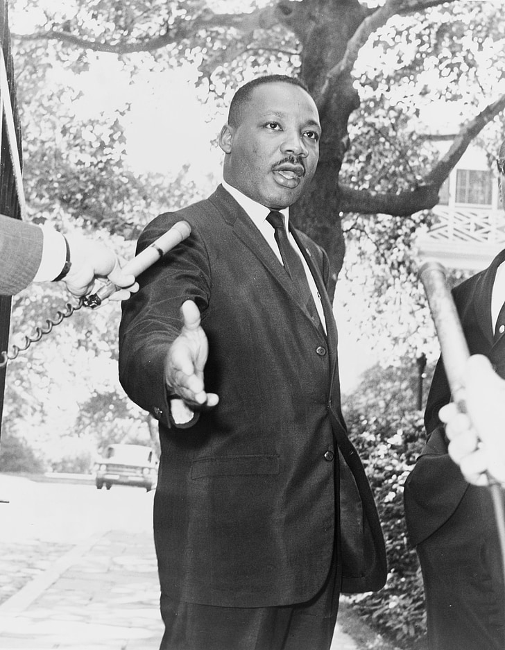 photo of Martin Luther King Jr. rising his right hand
