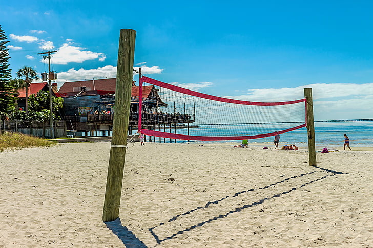 red and white volleyball net on the beach