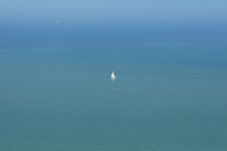 white sailboat in middle of sea