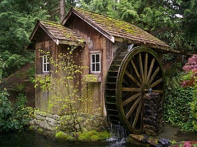 photo of brown house with water mill