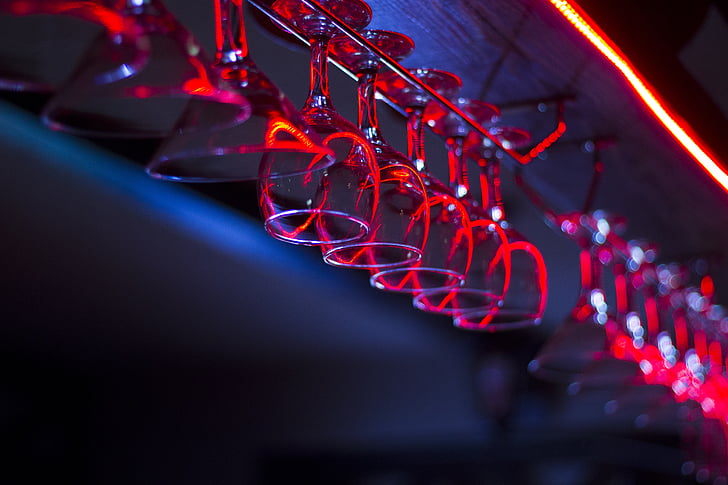 selective focus photo of champagne glasses hanging on rack