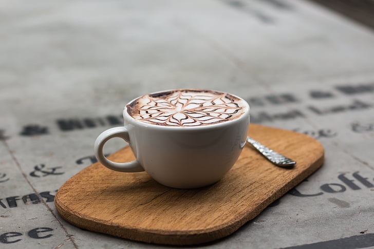 ceramic coffee mug with coffee latte on board