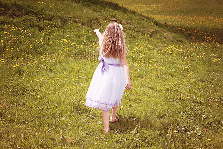 girl standing on grass field