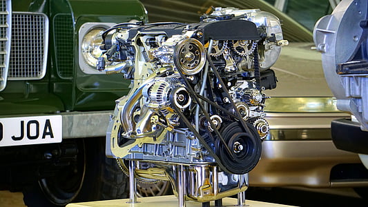 silver vehicle engine beside green vehicle