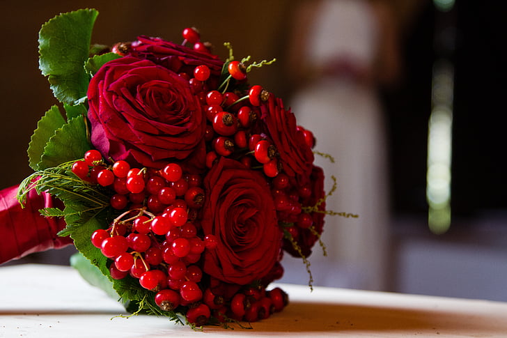 red rose bouquet on brown wooden surface