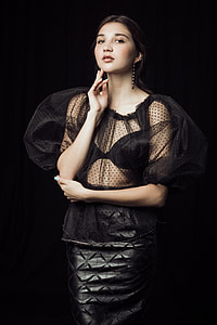 woman in black mesh illusion dress posing for photo