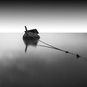 grayscale photography of boat on body of water