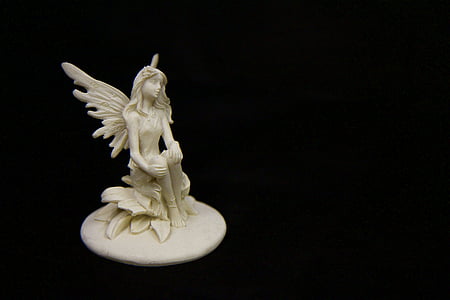 shallow focus of white ceramic angel figurine